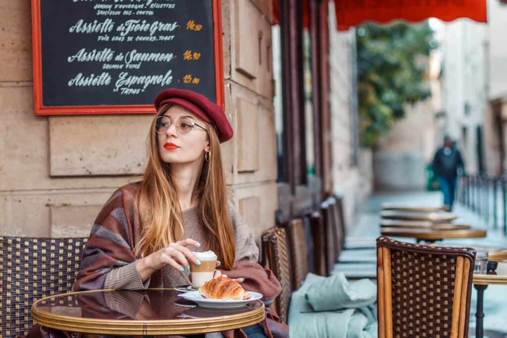 woman eating at a sidewalk cafe in Paris
